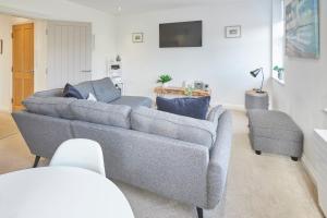 a living room with a gray couch and a chair at Host & Stay - Number 2 at Pannett Apartments in Whitby