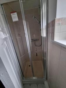 a shower with a glass door in a bathroom at A Beautiful Premium 4-Bedroom House With Parking (Reading West) in Reading