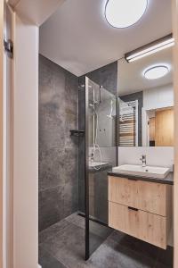 a bathroom with a sink and a shower at Apartamenty Świnoujście - Sun Towers 90 in Świnoujście