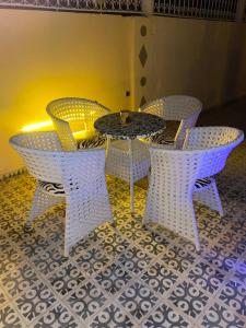 a table and chairs sitting on a tiled floor at Dar izem in Tafraout