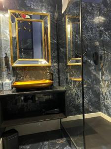 een badkamer met een gele wastafel en een spiegel bij LUX 114 APARTMENT in Košice