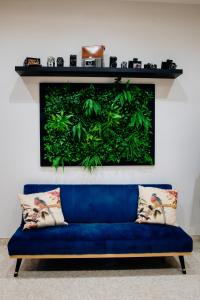 a blue couch in a room with a green wall at The Lovers Suite in Cava deʼ Tirreni