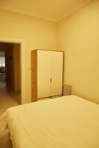 a bedroom with a bed with a cupboard and a chair at Sisli Centre Lux in Istanbul