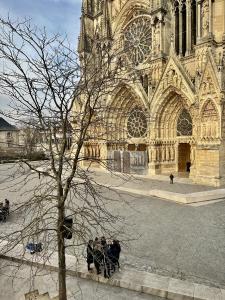 a group of people sitting in front of a cathedral at The Peregrines Nest in Reims