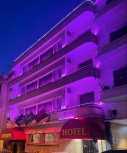 a hotel with purple lights on the side of it at Astoria in Casablanca