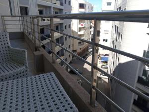 a balcony with a bench and a view of a street at Nouvel appartement climatisé in Fez