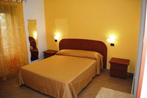a bedroom with a large bed and two night stands at B&B Insula Portus in Fiumicino