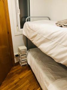 - une chambre avec 2 lits et une petite table de nuit dans l'établissement Barcelona me enamora, à Barcelone