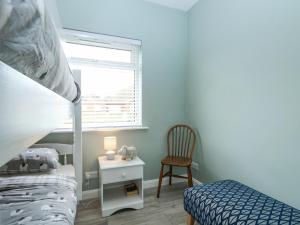 a bedroom with a bunk bed and a chair at 12 Siesta Mar in Norwich