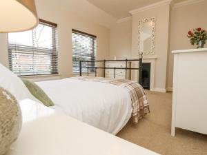 a bedroom with two beds and a fireplace at Seagulls Perch in Cowes