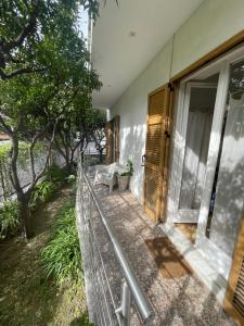 a porch of a house with a bench and a window at VILLA ROMANA in Diano Marina
