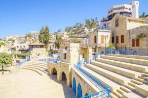 a group of stairs and a bridge in a city at אורות בעתיקה - צימרים ונופש בצפת in Safed