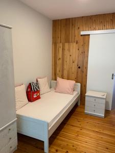 a bedroom with a bed with a wooden wall at ZeusPlace Park View Apartment Paralia Katerini in Paralia Katerinis