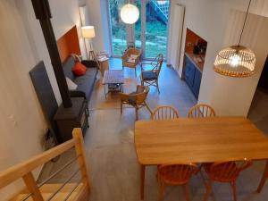 a living room with a wooden table and chairs at Gîte du Bon Pays in Frontenay