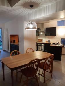 a dining room table and chairs in a kitchen at Gîte du Bon Pays in Frontenay +9 photos