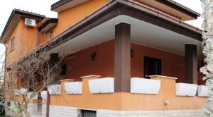 an orange building with white panels on the side of it at B&B Insula Portus in Fiumicino