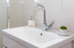 a sink with a faucet and a soap dispenser on it at Lucas apartment 1 in Athens +29 photos