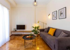 a living room with a couch and a table at Lucas apartment 1 in Athens