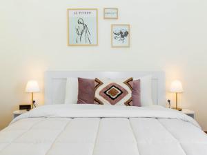 a bedroom with a white bed with pillows at Lucas apartment 1 in Athens