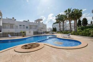 a swimming pool in front of a house at El Puerto I 1-3 in Cala D'or