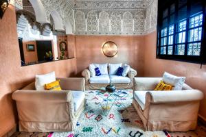 a living room with two couches and a table at Dafa Splendide Riad Agadir résidentiel 8 or 9 Px in Agadir