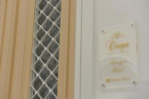 a sign on a door with a glass window at Oisyra Boutique Suites in Ermoupoli