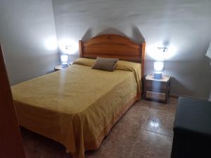 a bedroom with a large bed with two night stands at San Ramón centro Benicarló in Benicarló