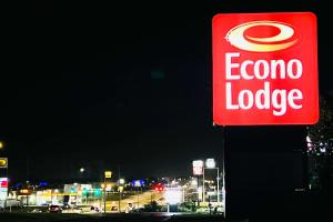 a sign for a corona lodge on the side of a gas station at Econo Lodge Ardmore in Ardmore +45 photos