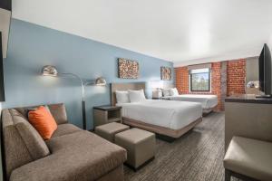 een hotelkamer met 2 bedden en een bank bij Hyatt House Sacramento-Midtown in Sacramento