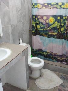 a bathroom with a toilet and a shower curtain at Appart-hotel Veras Samana No 12 in Santa Bárbara de Samaná