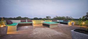 a patio with benches and tables on a rooftop at Forestville Yala in Yala