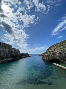 a view of the ocean from a bridge at Best Of Xlendi SeaFront Apartments in Xlendi