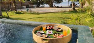 uma cesta cheia de comida ao lado de uma piscina em ALOE Beach Villa 1 em Ao Nam Mao