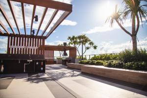 a patio with palm trees and the sun in the sky at Studio Boutique in Porto Alegre