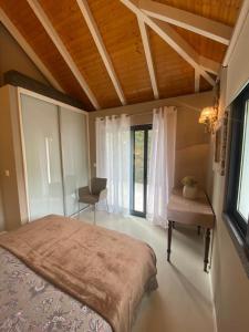 a bedroom with a large bed and a desk and window at Casa de Prazeres in Prazeres +142 photos