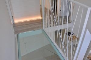 a glass stair case with a dog under it at Villa di Design con Giardino e Spa in Cittá in Cuneo