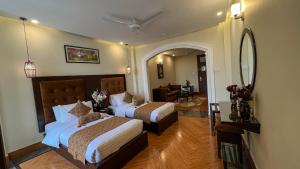 Habitación de hotel con 2 camas y espejo en Hotel One Swat, en Swat