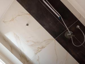 a shower with a white marble shower stall at Hotel Orchidea in Bardolino