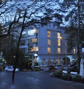 a building with lights on in a parking lot at Hotel Diplomat, Colaba in Mumbai