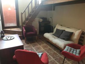 a living room with a couch and two chairs at Cal Fusté de Peramola in Peramola