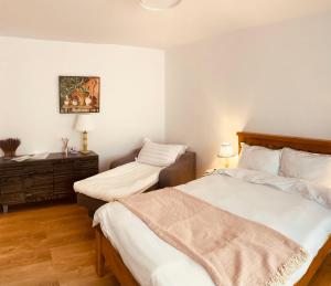 a bedroom with two beds and a dresser in it at Warm and cozy studio flat near Straja in Uricani