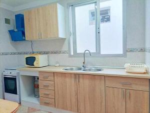 a kitchen with a sink and a window at Apartamento Vista a la Isla in Carboneras