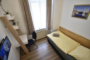 a bedroom with a bed and a desk and a window at Am Schloss 15 in Schwerin