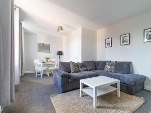 a living room with a couch and a table at Lily Apartment 2-Remarkable 2 Bed Bedlington in Bedlington