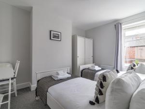 a hotel room with two beds and a window at East House - Inviting 3 Bed Stakeford in Choppington