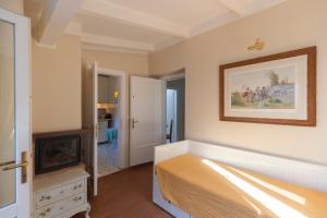 a bedroom with a bed and a painting on the wall at Maisonette in Portoferraio