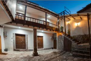 a house with a balcony and a stairway at Cusco'sHome 3 in Cusco