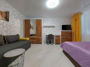 a living room with a couch and a bed at Стильні апартаменти Кравчука 10 LutskDoba in Lutsk