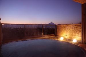 a view of a pool on a balcony at night at Hotel Kaminoyu Onsen in Kai