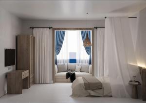 a bedroom with a bed and a couch in front of a window at Leo SereneS Hotel in Alacati